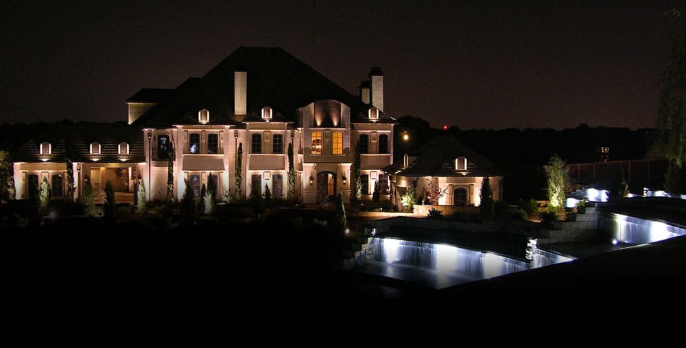 A large home's exterior lit up at night