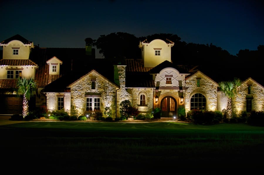 Outdoor lighting illuminates a beautiful University Park home