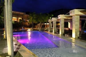 Colorful Poolside lighting add to the beauty of a modern swimming pool