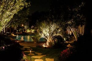 A Stone path cuts through landscaping leading up to a pool