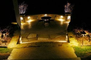 patio with chairs and table lit up