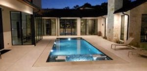 Backyard pool lighting in a courtyard