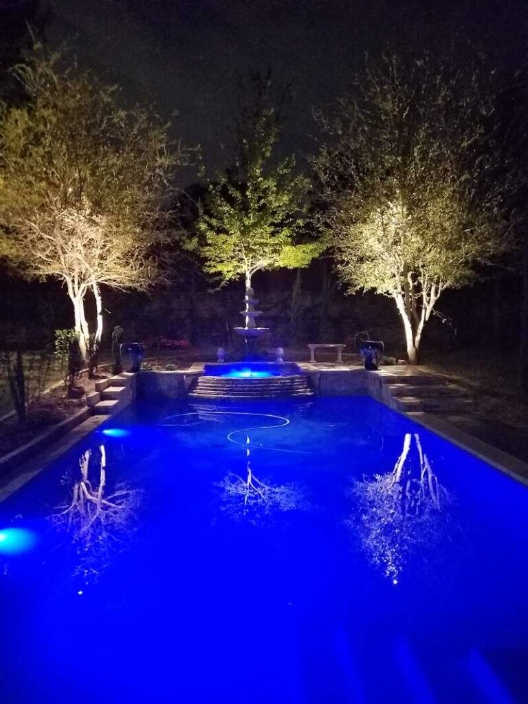 pool lit up by outdoor lighting