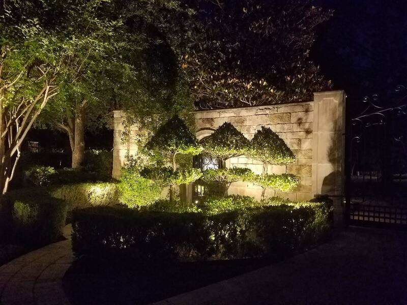 gate entrance lit up by outdoor lighting