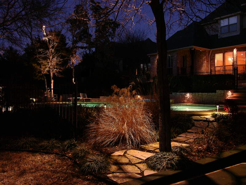 outdoor backyard area lit up by outdoor lighting