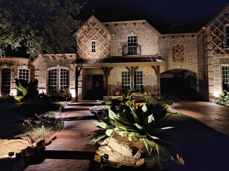 home lit up by outdoor lighting