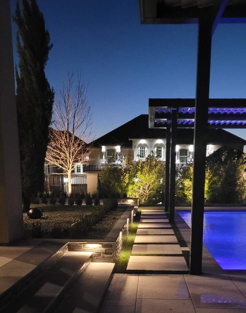 pool lit up with outdoor lighting