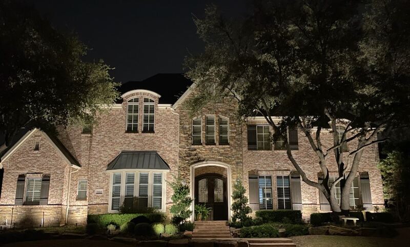 beautiful house lit up with outdoor lighting
