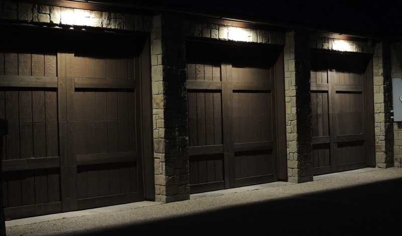 garage doors lit up by outdoor lighting