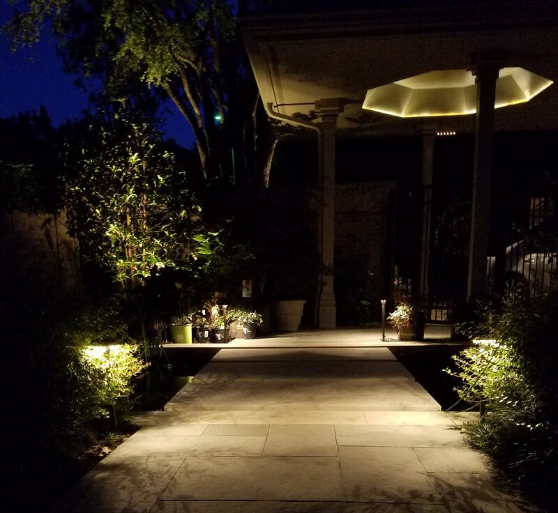 backyard being lit up by outdoor lighting