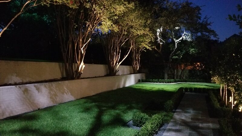 backyard lit up by outdoor lighting