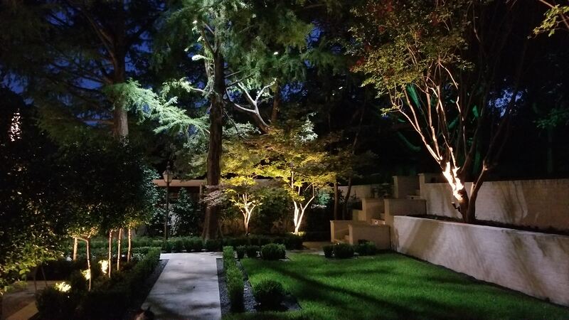 outdoor backyard are lit up by outdoor lighting