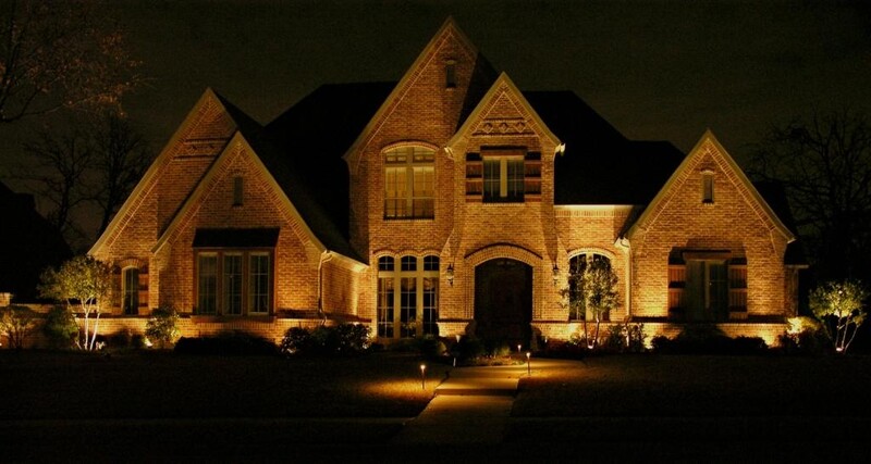 a house lit up with warm toned outdoor lighting