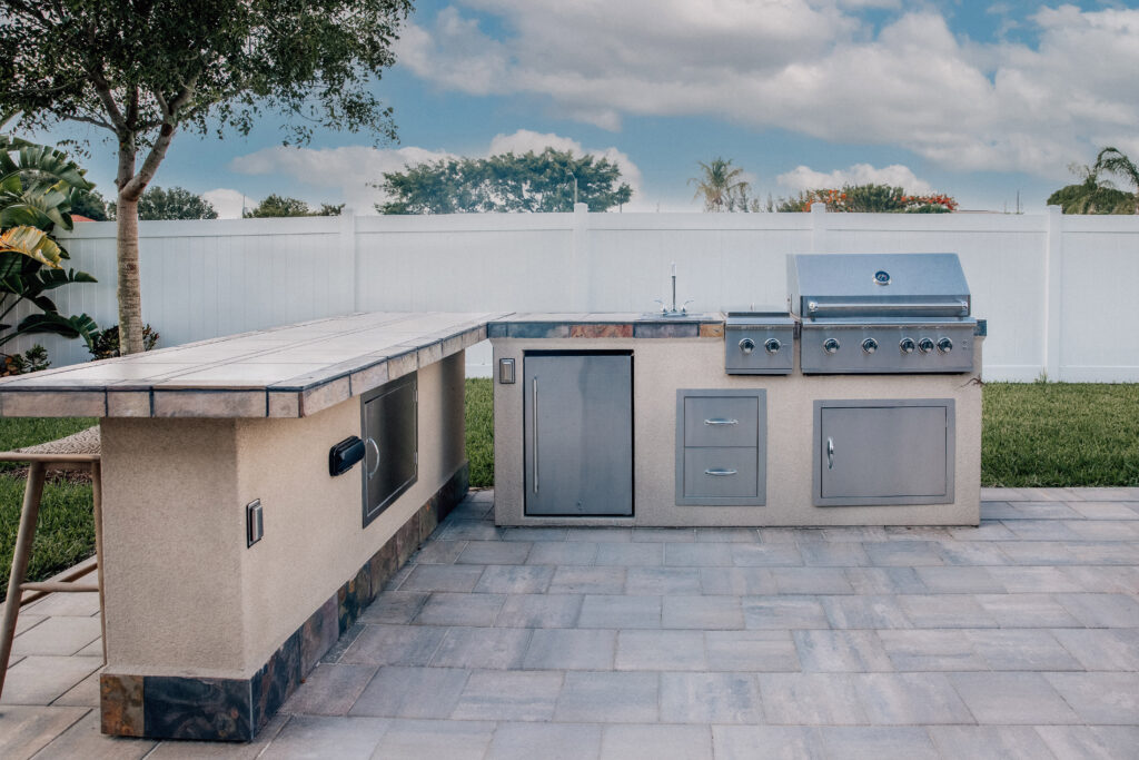 An outdoor kitchen in a backyard.