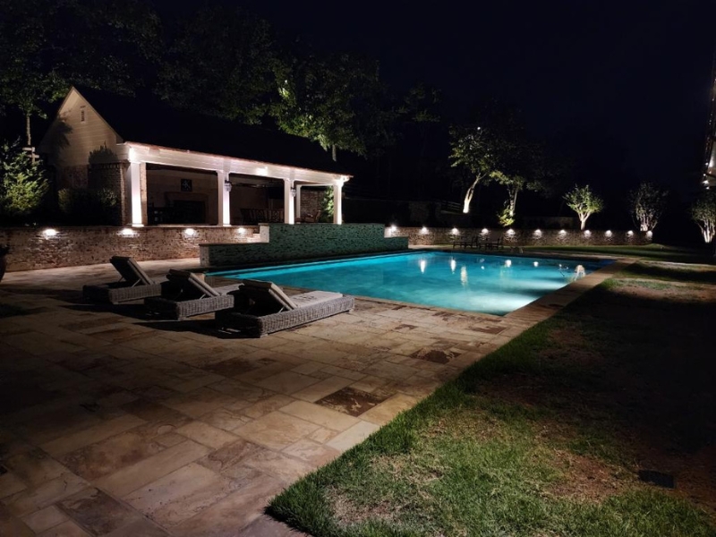 pool lit up with pool deck lighting