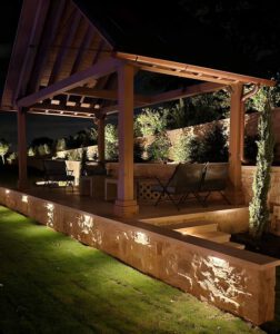 Lighted pergola and wall at night